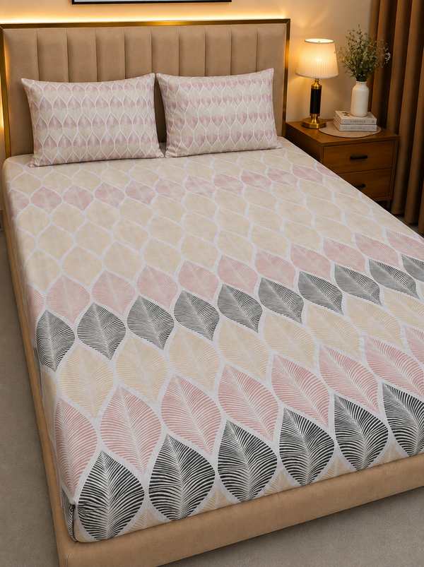 A bed dressed in a patterned duvet cover and two matching pillowcases, shown in a styled bedroom with a padded beige headboard, bedside lamp, and nightstand.